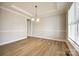 A clean, neutral dining area with wood floors and large windows offers ample natural light at 509 Abelia Ln, Tega Cay, SC 29708