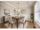 This dining room features hardwood floors, elegant lighting, and neutral tones, perfect for gatherings at 509 Abelia Ln, Tega Cay, SC 29708