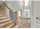 A grand foyer with hardwood floors, a staircase, and a bright entry welcomes you to the home at 509 Abelia Ln, Tega Cay, SC 29708