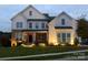 Charming home with mixed brick and siding exterior, well-lit entrance, and manicured lawn at 509 Abelia Ln, Tega Cay, SC 29708