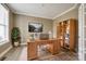 A well-lit home office with built-in shelving, hardwood floors, and modern decor at 509 Abelia Ln, Tega Cay, SC 29708