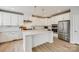 Modern kitchen boasts white cabinetry, center island, stainless steel appliances and pendant lighting at 509 Abelia Ln, Tega Cay, SC 29708