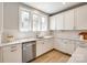 Contemporary kitchen with white cabinets, stainless steel dishwasher, and stone countertops at 509 Abelia Ln, Tega Cay, SC 29708