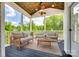Enjoy outdoor living on this screened porch with comfortable seating and a view of the landscape at 509 Abelia Ln, Tega Cay, SC 29708