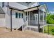 Enjoy outdoor living with a charming screened-in porch, accessible by stairs and a brick patio at 509 Abelia Ln, Tega Cay, SC 29708