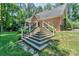 Multi-tiered deck and stairs in a sprawling backyard surrounded by lush greenery and privacy at 5485 Deer Run Ct, Davidson, NC 28036