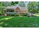 Backyard showcasing a spacious deck, lawn and landscaped garden at 5485 Deer Run Ct, Davidson, NC 28036