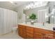 Bathroom featuring a double vanity with an expansive mirror, and a shower with curtain at 5485 Deer Run Ct, Davidson, NC 28036