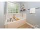 Relax in this soaking tub with stylish tile accents, perfect for unwinding after a long day at 5485 Deer Run Ct, Davidson, NC 28036