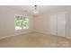 Well-lit bedroom with carpeted floor, closet, and a window at 5485 Deer Run Ct, Davidson, NC 28036
