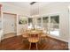 Cozy dining area bathed in natural light, complemented by elegant wood flooring at 5485 Deer Run Ct, Davidson, NC 28036