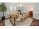 Elegant dining room featuring a modern chandelier, neutral tones, and a stylish wooden table set at 5485 Deer Run Ct, Davidson, NC 28036