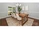 Dining room features a stylish chandelier, neutral walls, and a large window with natural light at 5485 Deer Run Ct, Davidson, NC 28036