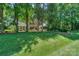 A beautiful two-story brick home nestled among mature trees and landscaping at 5485 Deer Run Ct, Davidson, NC 28036