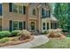 Charming brick home with black door, bay window and manicured front garden at 5485 Deer Run Ct, Davidson, NC 28036