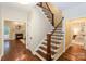 Elegant foyer with staircase, showcasing seamless transitions to the living room and dining areas at 5485 Deer Run Ct, Davidson, NC 28036