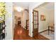Welcoming foyer features hardwood floors, staircase, and a glimpse into the living room with fireplace at 5485 Deer Run Ct, Davidson, NC 28036