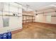 Spacious garage with ample storage shelving, ready for cars, projects, and organization at 5485 Deer Run Ct, Davidson, NC 28036