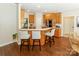 Kitchen with breakfast bar seating, opening to dining area, offering seamless flow and socializing at 5485 Deer Run Ct, Davidson, NC 28036