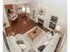 Aerial view of open-concept living space featuring fireplace, hardwood floors, and connection to kitchen and dining area at 5485 Deer Run Ct, Davidson, NC 28036