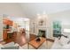 Open-concept living room with hardwood floors, a fireplace, and access to the dining area and kitchen at 5485 Deer Run Ct, Davidson, NC 28036