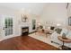 Inviting living room featuring a fireplace, hardwood floors, and comfortable seating with stylish decor at 5485 Deer Run Ct, Davidson, NC 28036