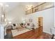 Bright living room showcasing vaulted ceilings, hardwood floors, and a cozy seating area with a fireplace at 5485 Deer Run Ct, Davidson, NC 28036