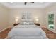 Calm main bedroom featuring tray ceilings, ample natural light, and neutral décor at 5485 Deer Run Ct, Davidson, NC 28036