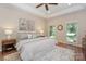 Relaxing main bedroom boasting tray ceilings, wood floors, and large windows for natural light at 5485 Deer Run Ct, Davidson, NC 28036