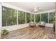 Cozy screened porch with wood-look floors, fan, and comfortable seating at 5485 Deer Run Ct, Davidson, NC 28036