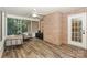 Cozy screened porch with wood-look floors, brick wall, and comfortable seating at 5485 Deer Run Ct, Davidson, NC 28036
