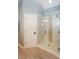The pristine shower features decorative tile accents and a seamless glass enclosure at 5485 Deer Run Ct, Davidson, NC 28036