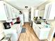 Efficient kitchen features white cabinetry, updated appliances, and laminate flooring at 5728 Rocbridge Ln, Charlotte, NC 28208