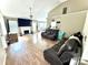 Open living room with a vaulted ceiling, fireplace, and view to the dining area at 5728 Rocbridge Ln, Charlotte, NC 28208