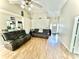 Open living room featuring light wood floors, neutral walls, and a view to the front entry at 5728 Rocbridge Ln, Charlotte, NC 28208