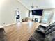 An open living room with a vaulted ceiling, fireplace, and access to additional rooms at 5728 Rocbridge Ln, Charlotte, NC 28208