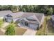 Aerial view of a single story home showcasing stone accents, two car garage, and well manicured lawn at 6007 Eleanor Rigby Rd, Charlotte, NC 28278