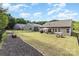 This backyard features a lush lawn, inviting patio space with a fire pit, and black fencing at 6007 Eleanor Rigby Rd, Charlotte, NC 28278