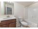 Bright bathroom with white sink, toilet, and shower/tub combo at 6007 Eleanor Rigby Rd, Charlotte, NC 28278