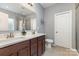 Modern bathroom with double sink vanity, large mirror, and tiled floors at 6007 Eleanor Rigby Rd, Charlotte, NC 28278