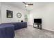 Comfortable bedroom with desk, tv, carpet, and ceiling fan at 6007 Eleanor Rigby Rd, Charlotte, NC 28278