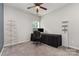 The bedroom boasts neutral walls and carpet, complemented by a dark desk and ceiling fan at 6007 Eleanor Rigby Rd, Charlotte, NC 28278