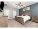 Comfortable bedroom with neutral walls, ceiling fan, wood furnishings, and carpeted floor at 6007 Eleanor Rigby Rd, Charlotte, NC 28278