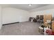 Spacious bonus room with neutral walls and carpet features a variety of items, including chairs and boxes at 6007 Eleanor Rigby Rd, Charlotte, NC 28278
