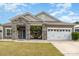 Lovely home featuring stone accents, a two-car garage, and a well-maintained lawn at 6007 Eleanor Rigby Rd, Charlotte, NC 28278