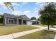 Charming single story home with stone accents, inviting front porch, and well-manicured lawn at 6007 Eleanor Rigby Rd, Charlotte, NC 28278