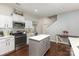Well-lit kitchen featuring white cabinets, stainless steel appliances, and a functional island at 6007 Eleanor Rigby Rd, Charlotte, NC 28278