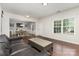 Open-concept living room and dining area with hardwood floors and lots of natural light at 6007 Eleanor Rigby Rd, Charlotte, NC 28278