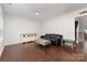 Spacious living room featuring hardwood floors, a large sofa, and neutral décor at 6007 Eleanor Rigby Rd, Charlotte, NC 28278