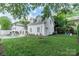 Charming white brick outbuilding overlooking the yard, pool and lush green lawn at 601 Cherokee Rd, Charlotte, NC 28207